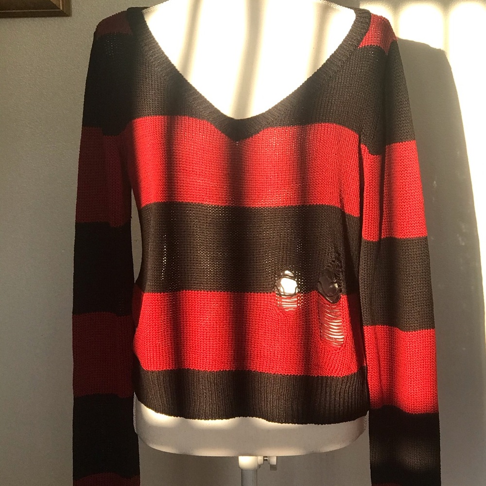 Red and black ripped sweater